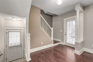 Foyer featuring dark hardwood flooring.