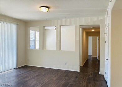 Empty room with dark wood-type flooring and basebo
