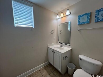 Bathroom featuring vanity, toilet, and tile patter