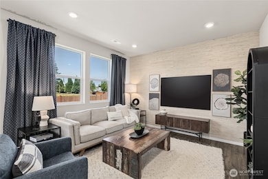 Open great room with large windows for natural light. Actual home is under construction. Colors, materials, and features may vary. See site agent for details.