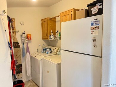 Indoor laundry with storage and refrigerator