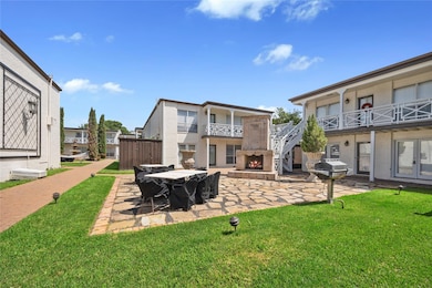 Back of property with a yard, a patio area, stucco