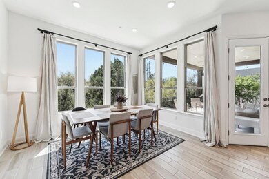 Dining area with recessed lighting, light wood fi