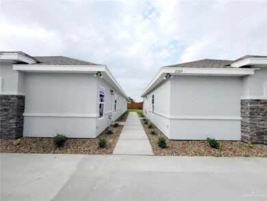 View of property exterior with stone siding and stucco siding
