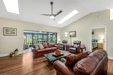 Living room featuring vaulted ceiling with skyligh