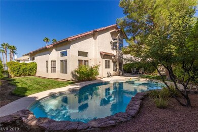 Sparkling pool and spa and grassy side yard...