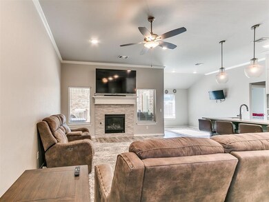 Living room with lofted ceiling, a stone fireplace