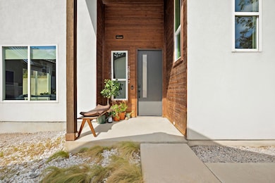View of exterior entry featuring stucco siding an