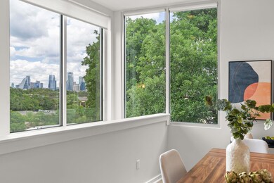 Sunroom featuring a skyline view