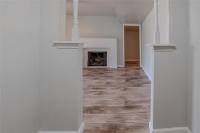 Unfurnished living room with light wood finished floors and a fireplace