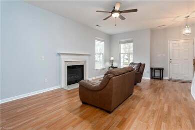 Living room with gas log fireplace and new laminate flooring.