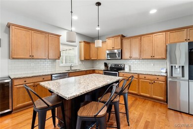 Kitchen with a breakfast bar area, light hardwood