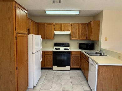 Kitchen featuring white appliances, under cabinet