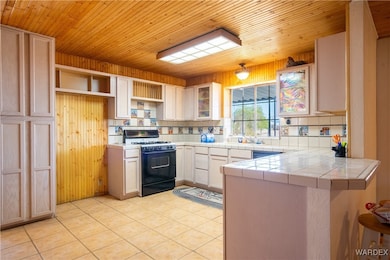Kitchen featuring tile counters, light tile patter