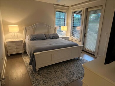 Bedroom featuring wood finished floors, access to