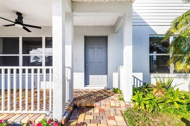 Entrance to property with ceiling fan and a porch