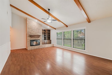Unfurnished living room featuring a large firepla