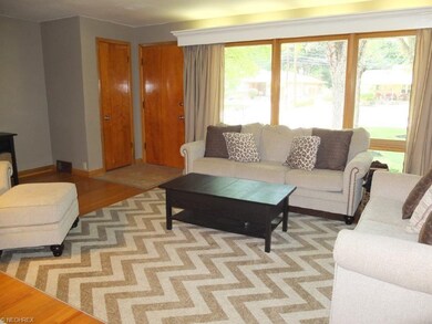 Living room with picture window and fireplace.