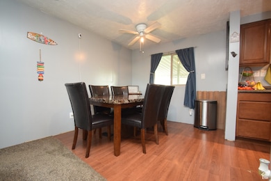 Dining room featuring light wood-type flooring and ceiling fan