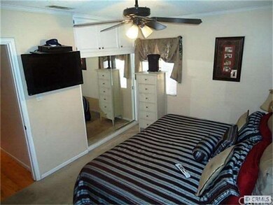 Mirrored Closets, Ceiling Fan Adorn The Master Bed