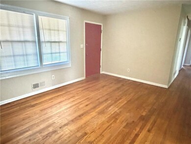 Spare room with baseboards and wood finished floors