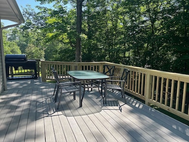 Wooden terrace with outdoor dining space and a grill