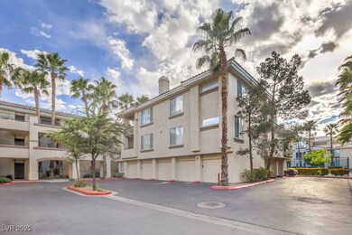 View of property featuring community garages