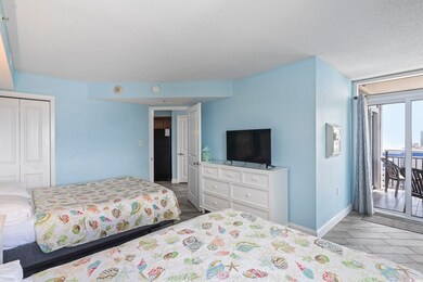 Tiled bedroom with a closet, access to exterior, a