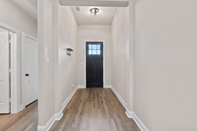 Doorway to outside with light wood-type flooring