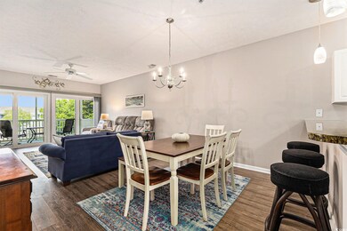 Dining room featuring ceiling fan, dark wood-style flooring, a chandelier, baseboards, and a textured ceiling