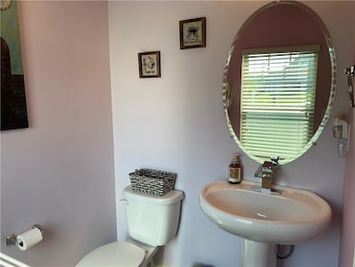 Half bath featuring toilet and a sink