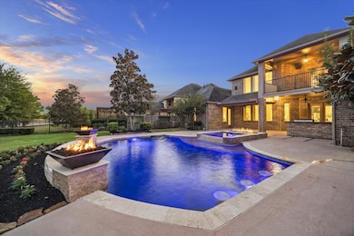 One of a kind backyard oasis featuring this mediterranean style heated pool & spa with built in seating, beautiful water features, fire bowls and ledges overlooking the lake and beautiful scenery.