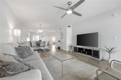 Living area with wood finished floors, a ceiling fan, and baseboards