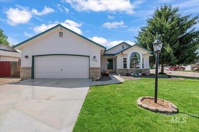 Single story home featuring brick siding, driveway, and an attached garage.  14x36 shop sits behind home.