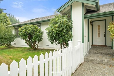 Front walk way with white picket fence.