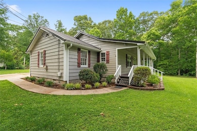 View of front of property featuring a front yard and a porch