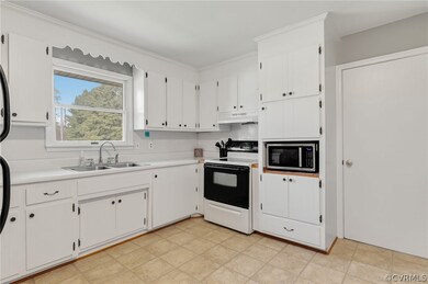 Kitchen featuring electric stove, light  floors, s