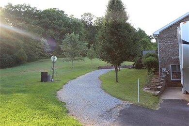 Crushed stone drive circles around the back of the