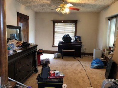 Misc room with ornate columns, light carpet, a textured ceiling, and ceiling fan