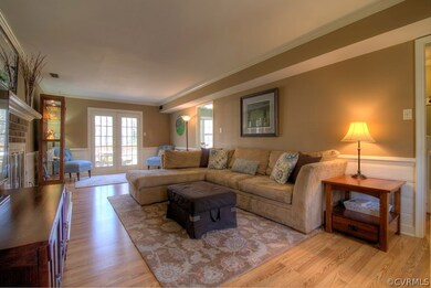 SPACIOUS family room features a brick, wood-burnin
