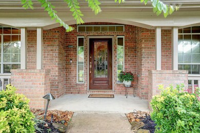  Lush landscaping with manicured crepe myrtles welcome you in to a gracious front porch that extends the length of the home.