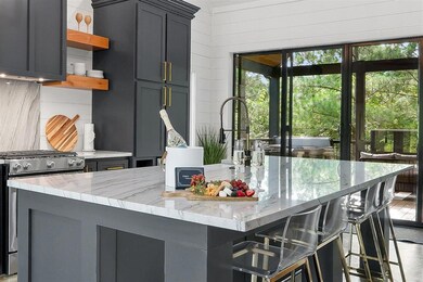 Kitchen with a kitchen bar, light stone countertop