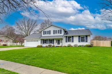 View of front facade featuring a front lawn and a garage