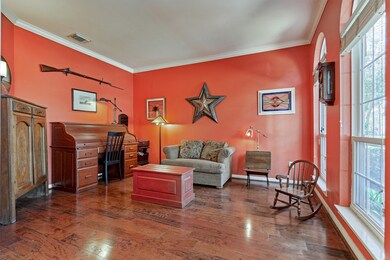 Study featuring engineered wood floors and crown molding.