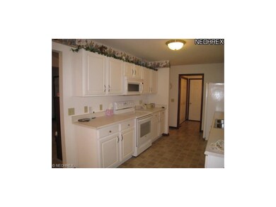 Bright and cheery, fully applianced kitchen.