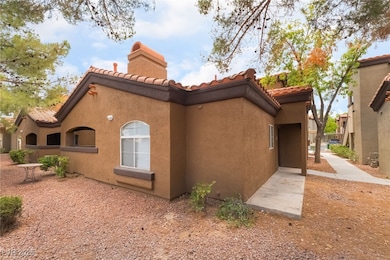 View of side of property with a tile roof, stucco