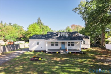 View of front of home featuring a porch, gravel driveway, and crawl space