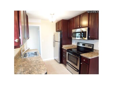 This kitchen has Kraftmaid cherry cabinets, stainl