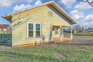 View of side of home with a yard
