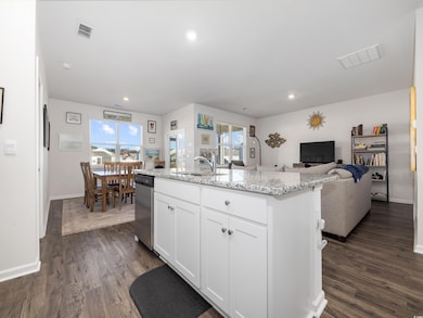 Kitchen featuring white cabinetry, a center island